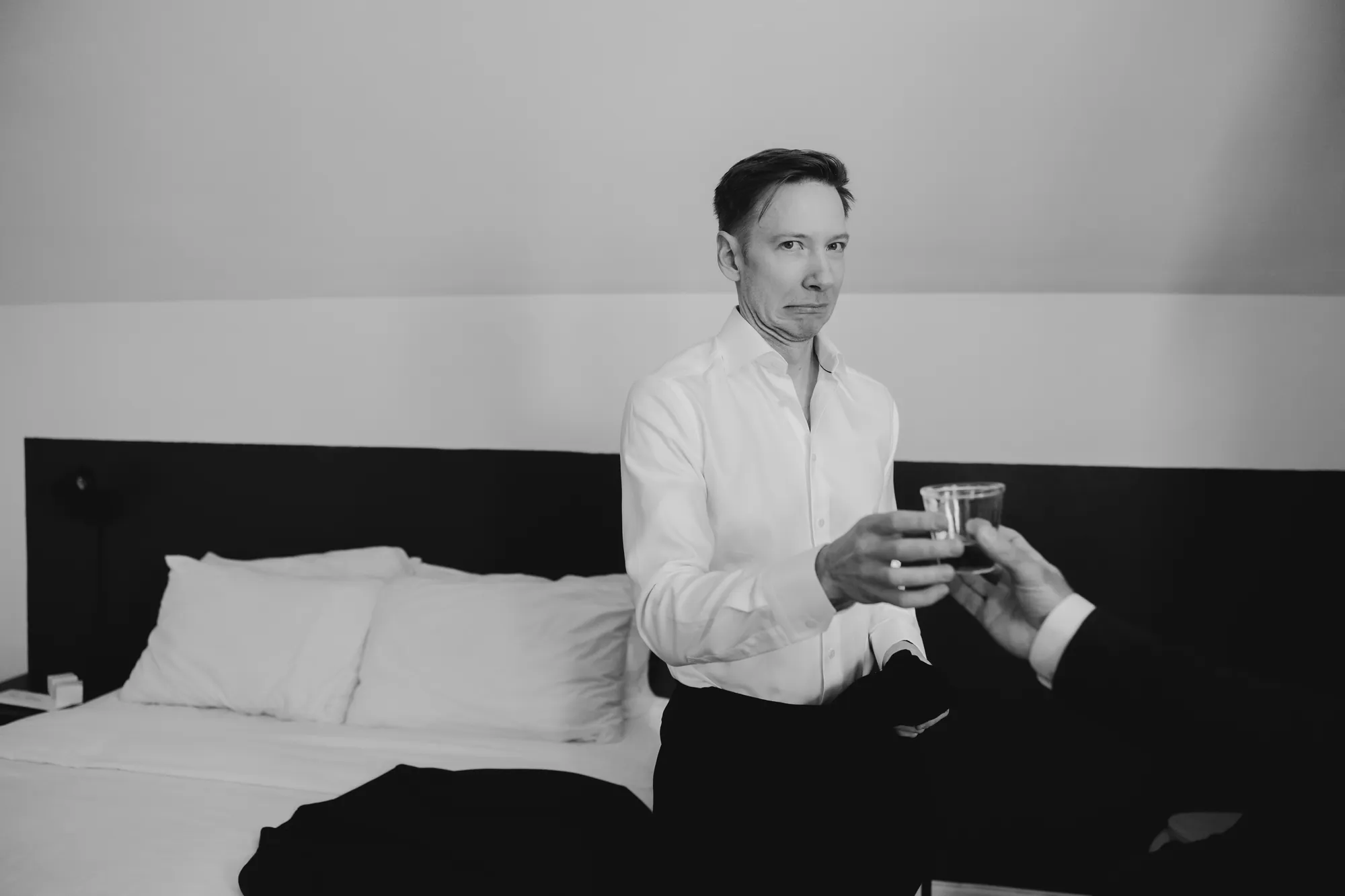 Marié avec drôle de visage devant son verre de wisky.